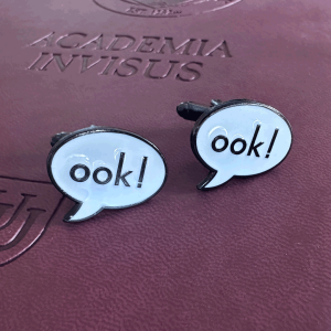 Ook! Cufflinks atop a Unseen University notebook