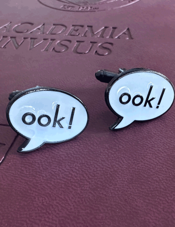 Ook! Cufflinks atop a Unseen University notebook