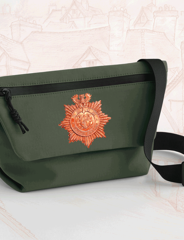 Forest green mini messenger bag with copper Ankh-Morpork City Watch badge and black adjustable strap.